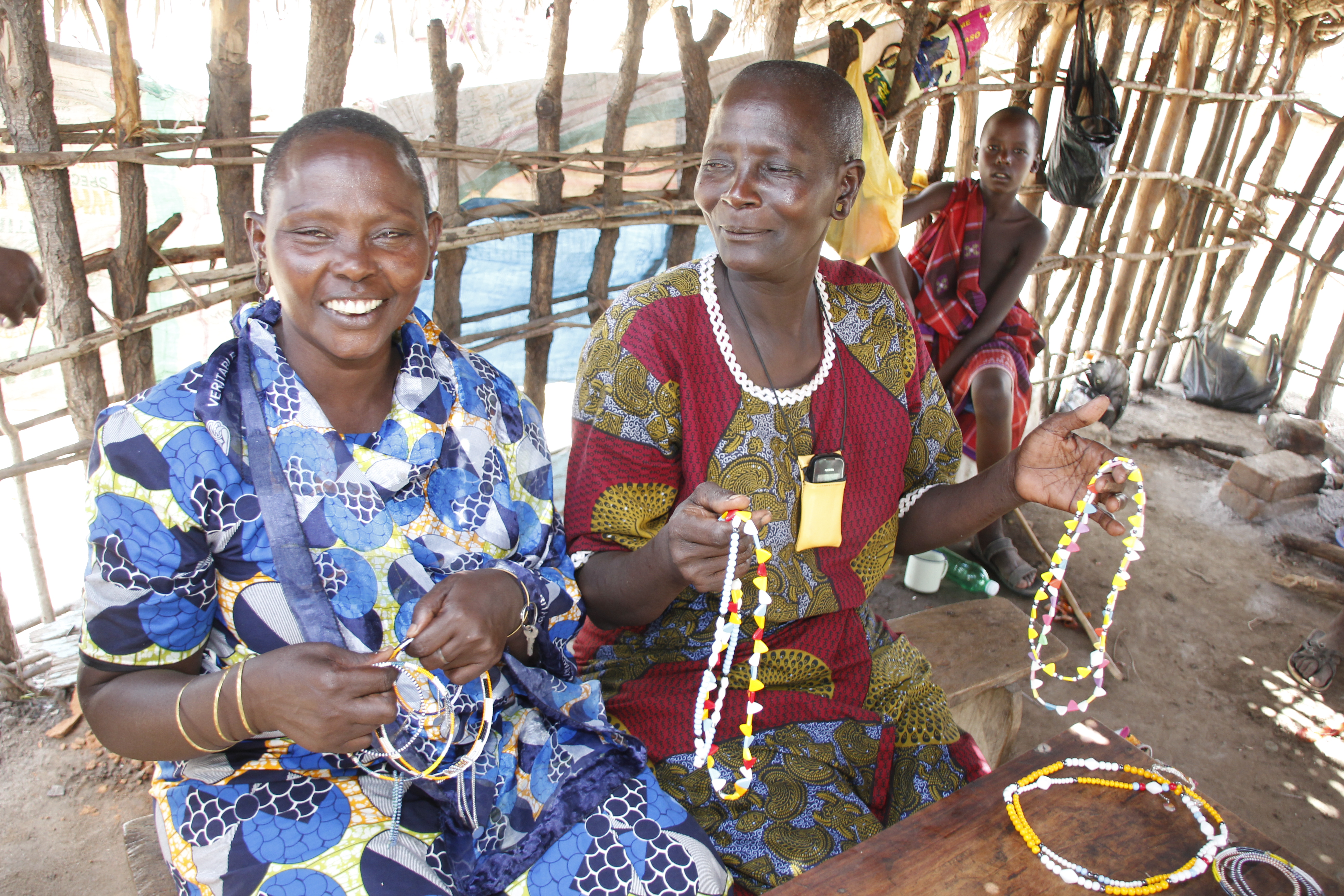 Kambalan kylässä asuvat Raheli Omari (vas.) ja Sabina Mwalimu tekevät maasaiden perinteisiä helmikoruja myyntiin.